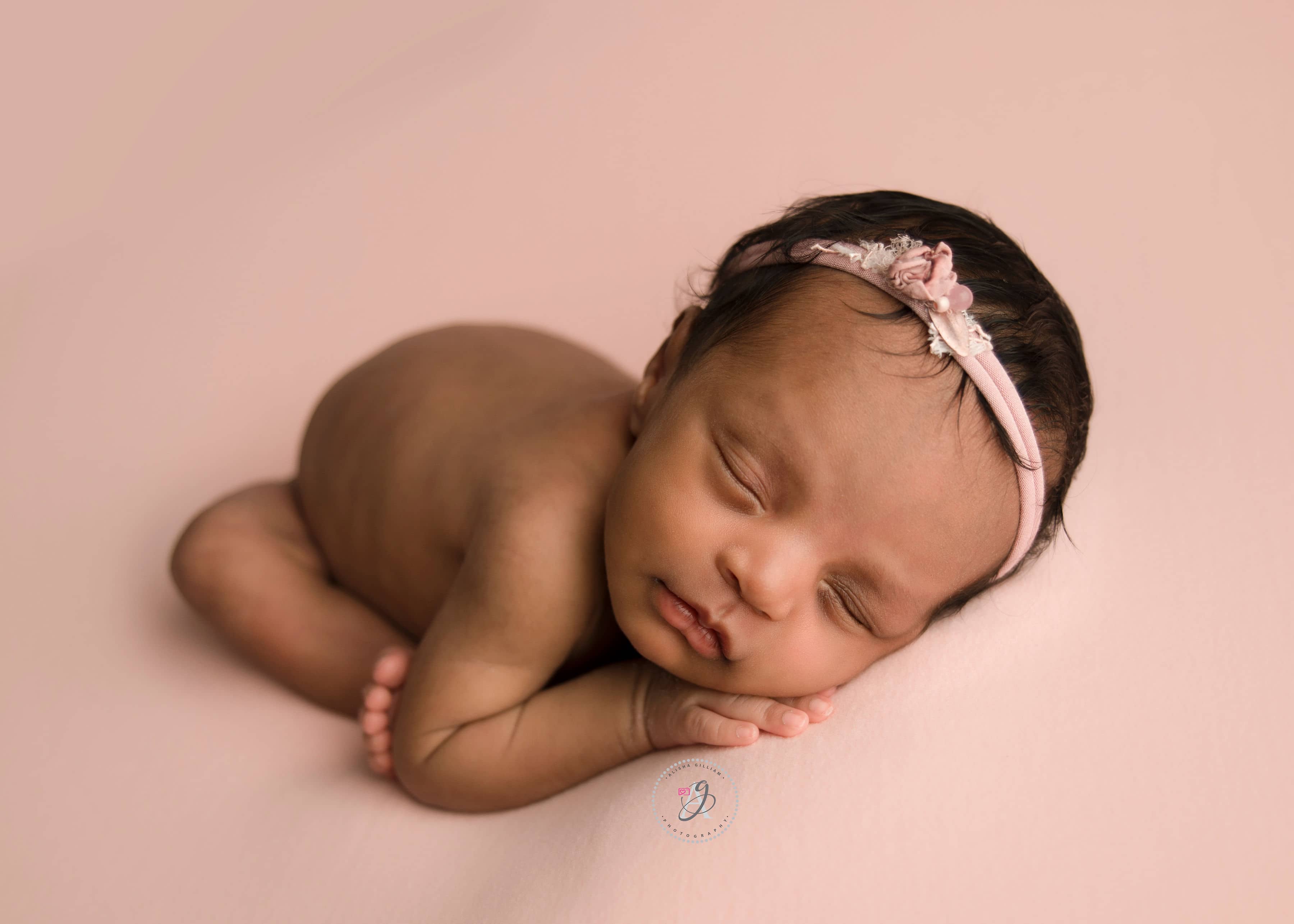 Professional newborn baby girl photoshoot in studio with older sister.