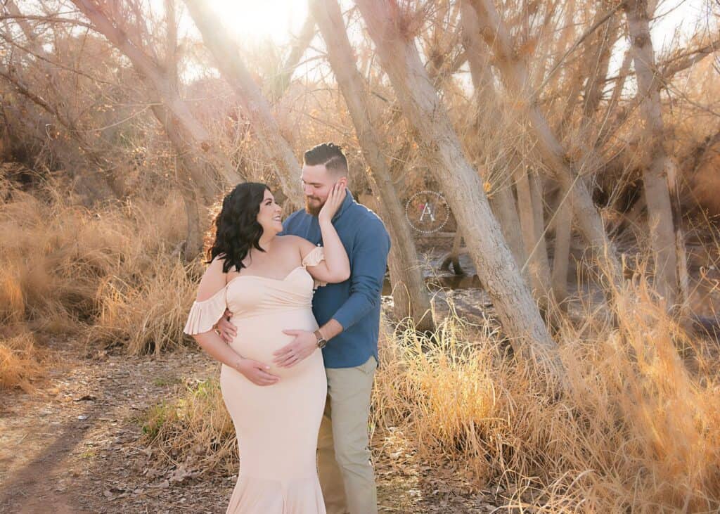 Outdoor maternity shoot with husband and wife at sunset.